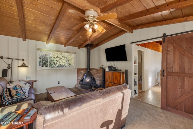 living room featuring lofted ceiling with beams, a barn door, a ceiling fan, wood ceiling, and carpet floors