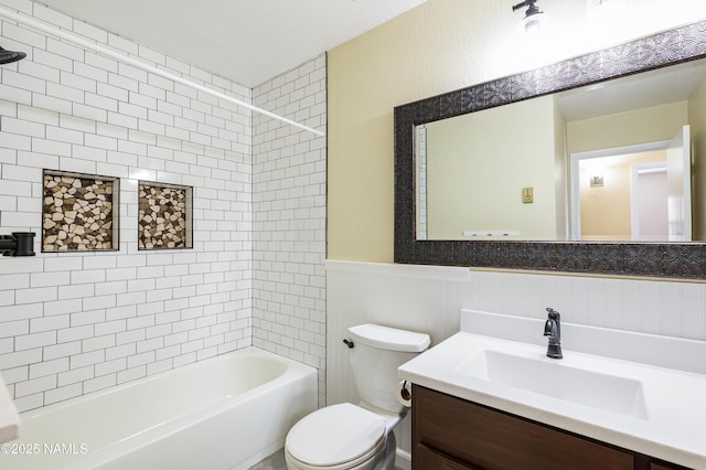 full bath with toilet, a wainscoted wall, shower / bathtub combination, and vanity