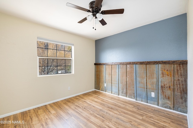 unfurnished room with ceiling fan, baseboards, and wood finished floors