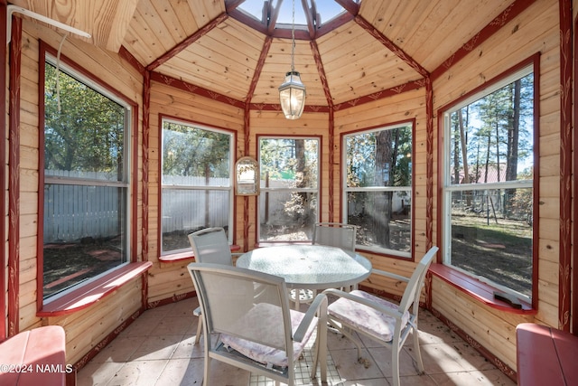 sunroom / solarium featuring wood ceiling and vaulted ceiling with skylight