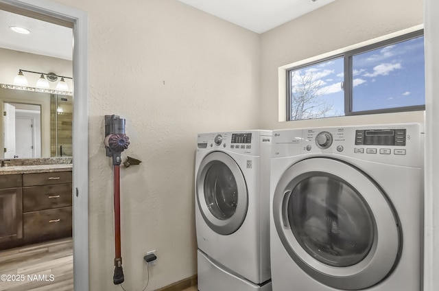 8841 E Rolling Thunder Dr, Flagstaff, AZ 86004 - laundry area with washing machine and clothes dryer and light wood-style flooring