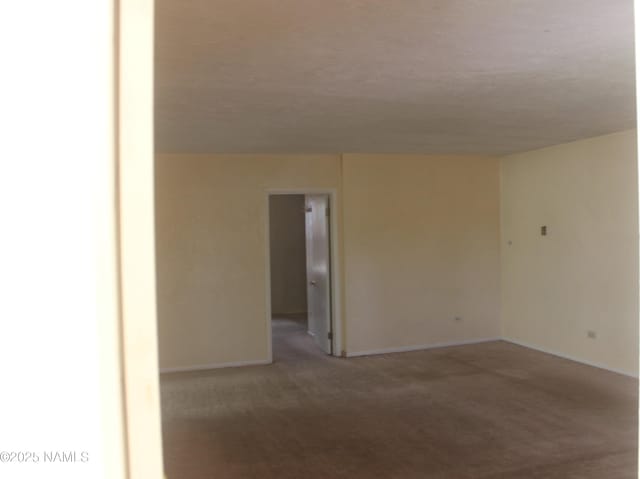 322 W Mahoney St, Winslow, AZ 86047 - empty room with carpet flooring and baseboards