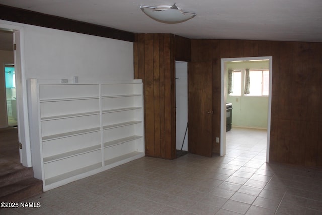 322 W Mahoney St, Winslow, AZ 86047 - empty room featuring wooden walls and light tile patterned floors