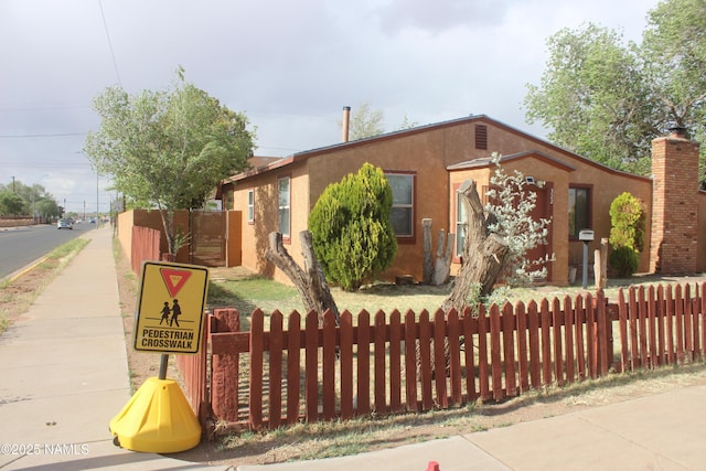 322 W Mahoney St, Winslow, AZ 86047 - view of front of home featuring a fenced front yard and stucco siding