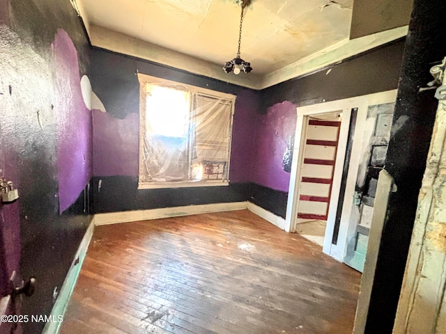 216 W 3rd St, Winslow, AZ 86047 - empty room with wood-type flooring and baseboards