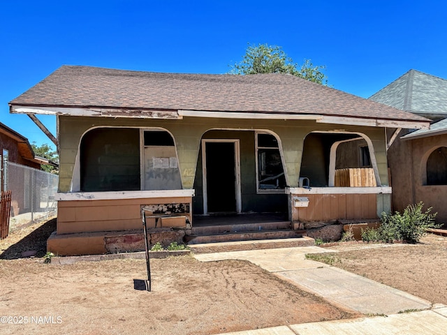 216 W 3rd St, Winslow, AZ 86047 - view of front facade with roof with shingles and a porch