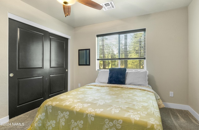 carpeted bedroom with a closet and ceiling fan