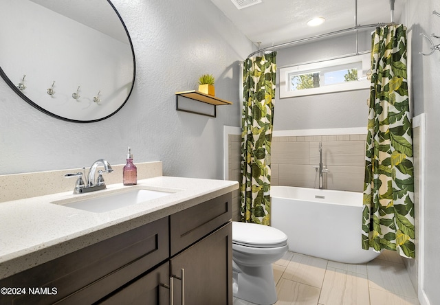 bathroom with vanity, toilet, and tile patterned floors