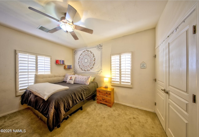 bedroom with carpet, multiple windows, visible vents, and a ceiling fan