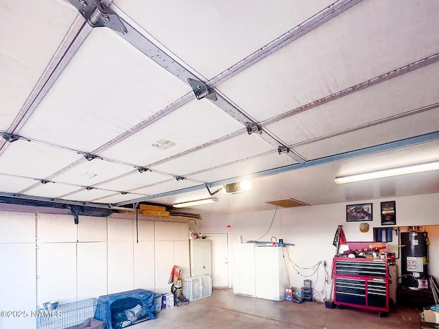 garage with water heater and a garage door opener