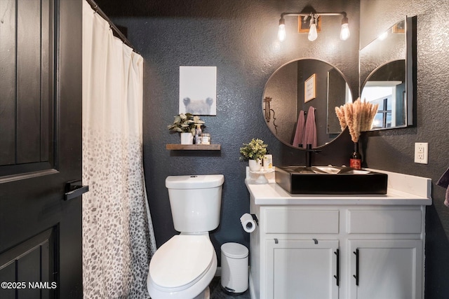 bathroom with toilet and vanity