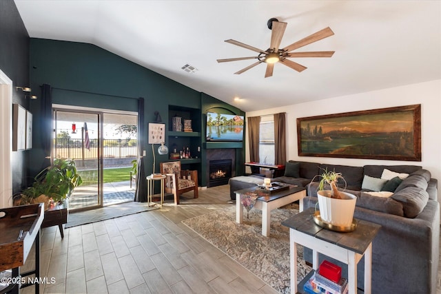 living room featuring ceiling fan and vaulted ceiling