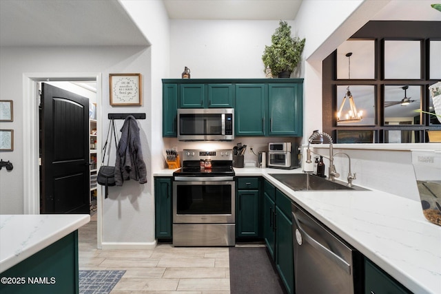 kitchen with sink, stainless steel appliances, and light stone countertops