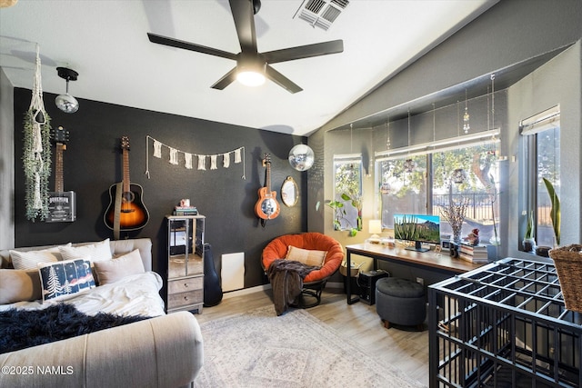 living room with vaulted ceiling, ceiling fan, and wood-type flooring