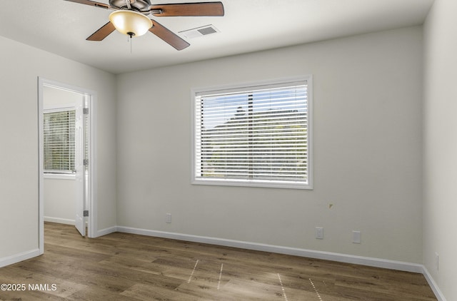9835 Pioneer Valley Rd, Flagstaff, AZ 86004 - unfurnished room with wood finished floors, ceiling fan, and baseboards