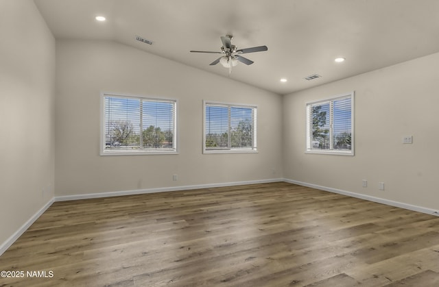 9835 Pioneer Valley Rd, Flagstaff, AZ 86004 - empty room featuring plenty of natural light, a ceiling fan, vaulted ceiling, recessed lighting, and wood finished floors