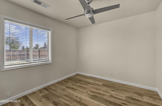 9835 Pioneer Valley Rd, Flagstaff, AZ 86004 - empty room with plenty of natural light, baseboards, wood finished floors, and a ceiling fan