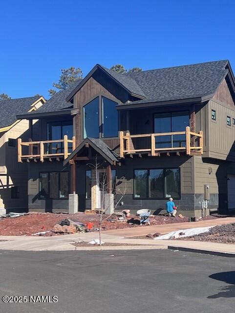 view of front of house featuring a balcony