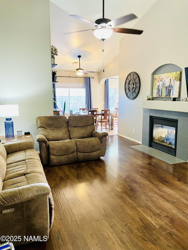 11677 W Cove Crest Dr, Bellemont, AZ 86015 - living room with ceiling fan, wood finished floors, baseboards, a fireplace, and high vaulted ceiling