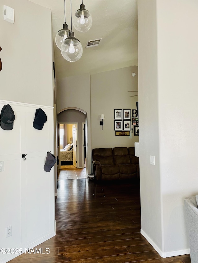 11677 W Cove Crest Dr, Bellemont, AZ 86015 - hallway with arched walkways and dark wood-style flooring