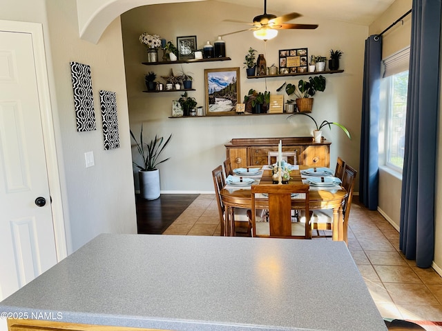 11677 W Cove Crest Dr, Bellemont, AZ 86015 - dining area with ceiling fan, arched walkways, tile patterned floors, baseboards, and vaulted ceiling