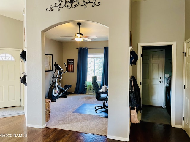 11677 W Cove Crest Dr, Bellemont, AZ 86015 - home office with arched walkways, a ceiling fan, wood finished floors, and baseboards