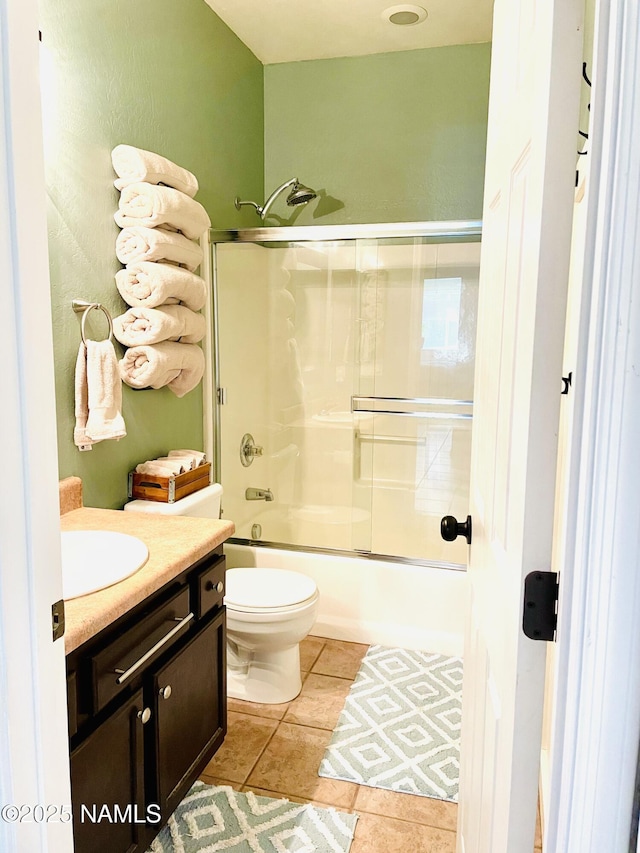 11677 W Cove Crest Dr, Bellemont, AZ 86015 - full bath with vanity, shower / bath combination with glass door, toilet, and tile patterned flooring