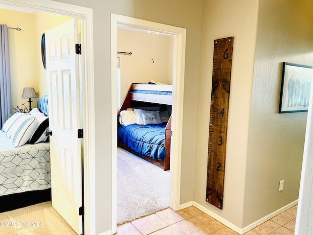 11677 W Cove Crest Dr, Bellemont, AZ 86015 - corridor with light tile patterned floors, light carpet, and baseboards