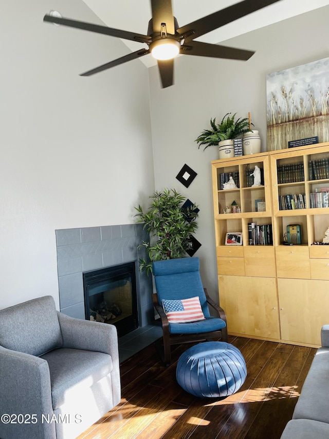 11677 W Cove Crest Dr, Bellemont, AZ 86015 - living area featuring dark wood-style floors, a ceiling fan, and a glass covered fireplace