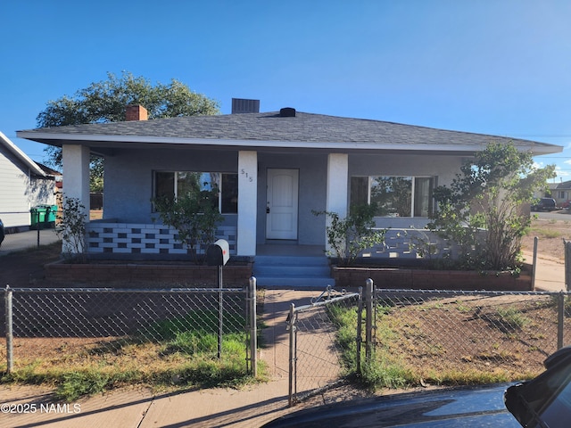 bungalow featuring a shingled roof, a fenced front yard, a gate, and stucco siding