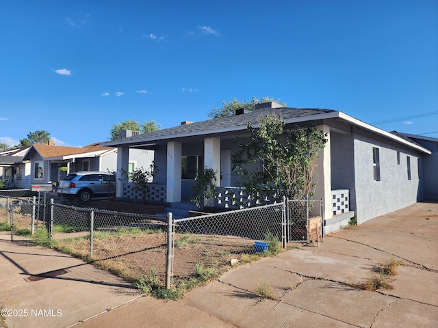 single story home featuring a fenced front yard, a gate, and stucco siding