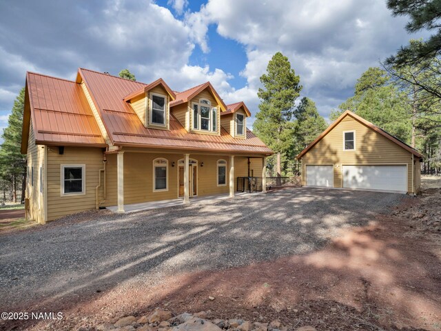 284 E Foothill Trl, Williams, AZ 86046 - view of front of house with a garage, an outbuilding, a porch, and metal roof