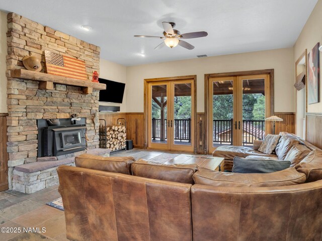 284 E Foothill Trl, Williams, AZ 86046 - living room featuring ceiling fan, french doors, visible vents, a wainscoted wall, and wooden walls