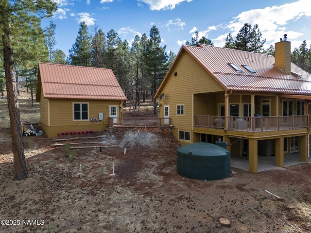 284 E Foothill Trl, Williams, AZ 86046 - rear view of house with metal roof, a chimney, and a standing seam roof