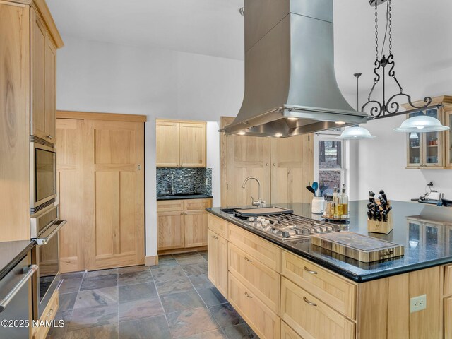 284 E Foothill Trl, Williams, AZ 86046 - kitchen featuring light brown cabinetry, appliances with stainless steel finishes, stone finish flooring, and wall chimney exhaust hood