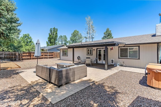 3425 W Mountain Dr, Flagstaff, AZ 86001 - rear view of house with french doors, a fenced backyard, a patio area, and a hot tub