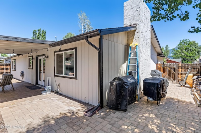 3425 W Mountain Dr, Flagstaff, AZ 86001 - back of property with a patio area, a chimney, and french doors