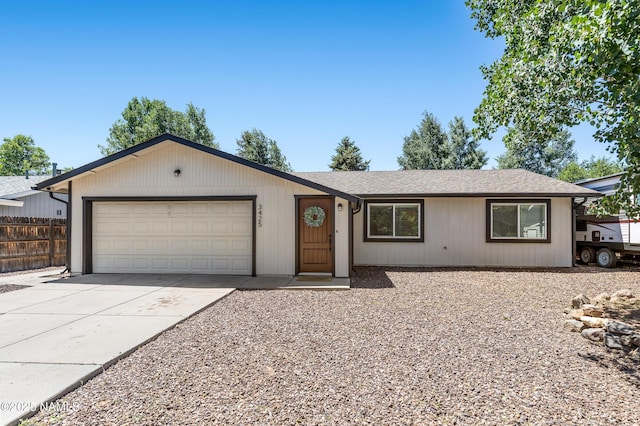 3425 W Mountain Dr, Flagstaff, AZ 86001 - ranch-style house with driveway, an attached garage, and roof with shingles