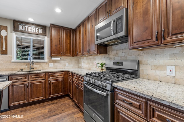3425 W Mountain Dr, Flagstaff, AZ 86001 - kitchen with stainless steel appliances, decorative backsplash, light stone counters, dark wood-style flooring, and recessed lighting