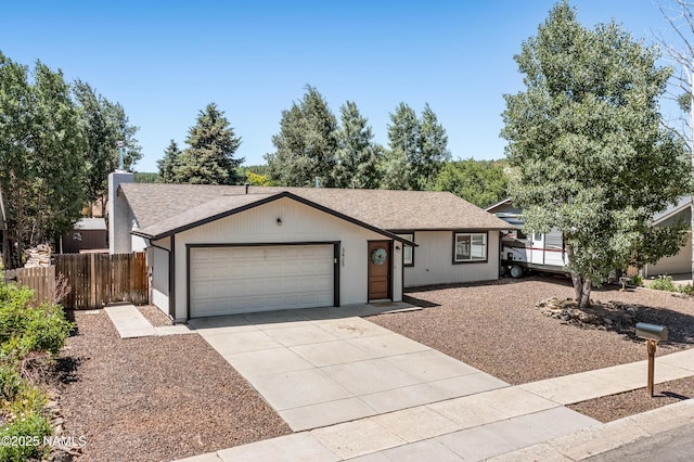 3425 W Mountain Dr, Flagstaff, AZ 86001 - single story home featuring concrete driveway, roof with shingles, and a garage