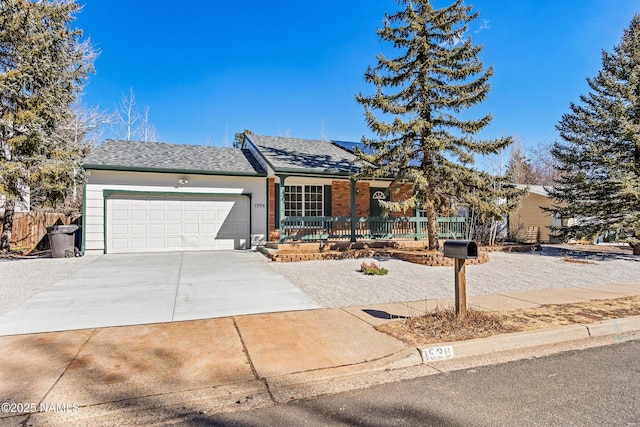 single story home featuring roof with shingles, brick siding, an attached garage, fence, and driveway