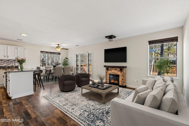 1536 N Foxglenn St, Flagstaff, AZ 86004 - living room featuring a ceiling fan, a fireplace, baseboards, and dark wood-type flooring