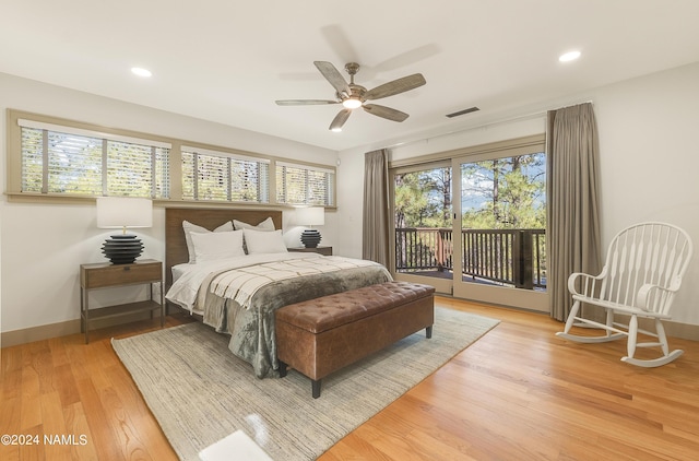 bedroom featuring wood-type flooring, multiple windows, access to exterior, and ceiling fan