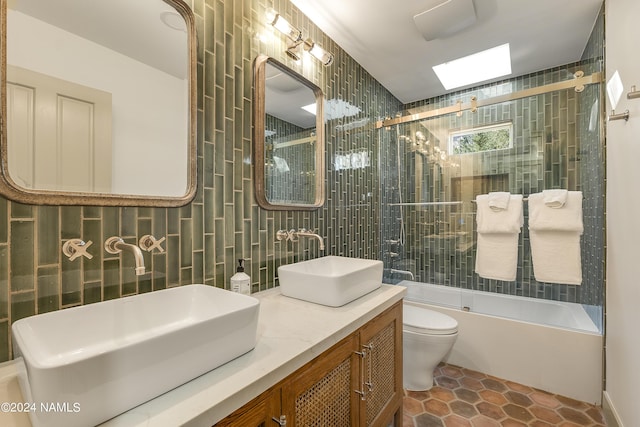 full bathroom with vanity, toilet, bath / shower combo with glass door, and tile patterned floors