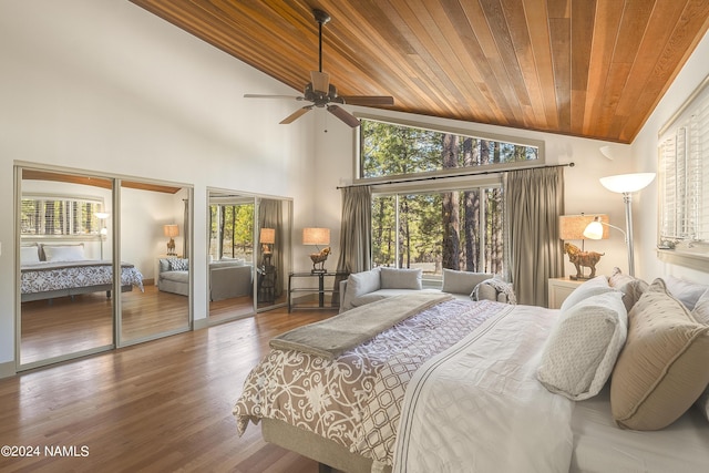 bedroom with hardwood / wood-style flooring, high vaulted ceiling, ceiling fan, and wood ceiling