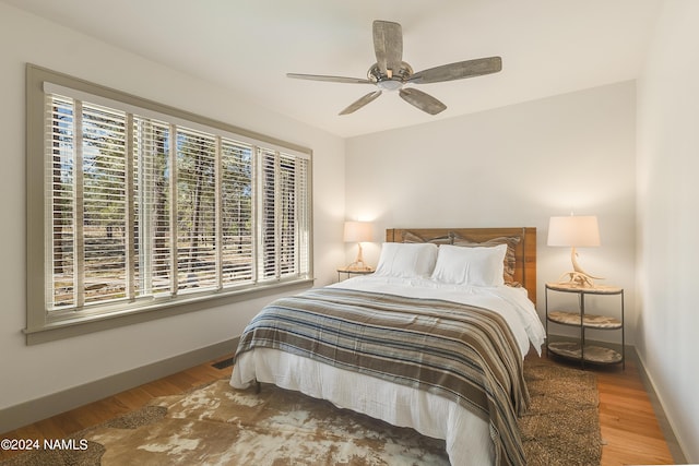 bedroom with hardwood / wood-style floors and ceiling fan