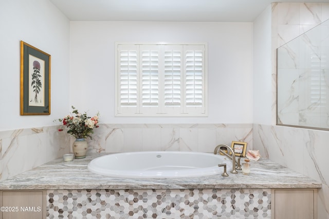 bathroom featuring tiled bath