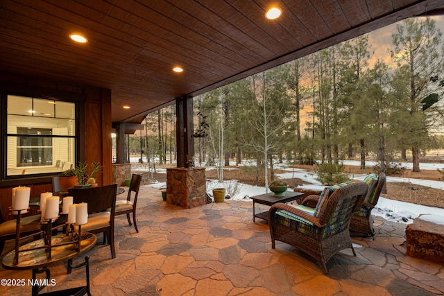 snow covered patio with an outdoor living space