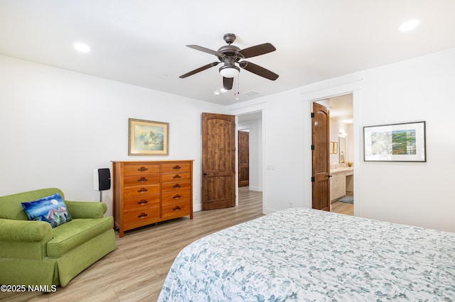 bedroom featuring ceiling fan, connected bathroom, and light hardwood / wood-style floors