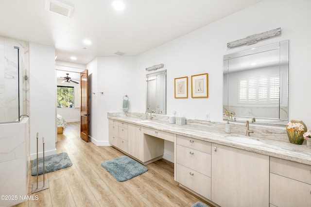 bathroom with vanity, hardwood / wood-style floors, and ceiling fan